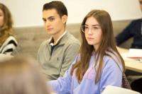 Focused students attending a classroom session and listening attentively during a lesson.