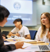 Students discussing ideas during an artificial intelligence class at Oxford.
