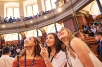 International students attending an event at a historic auditorium