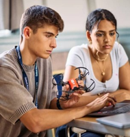 Students building and programming a drone in a tech workshop